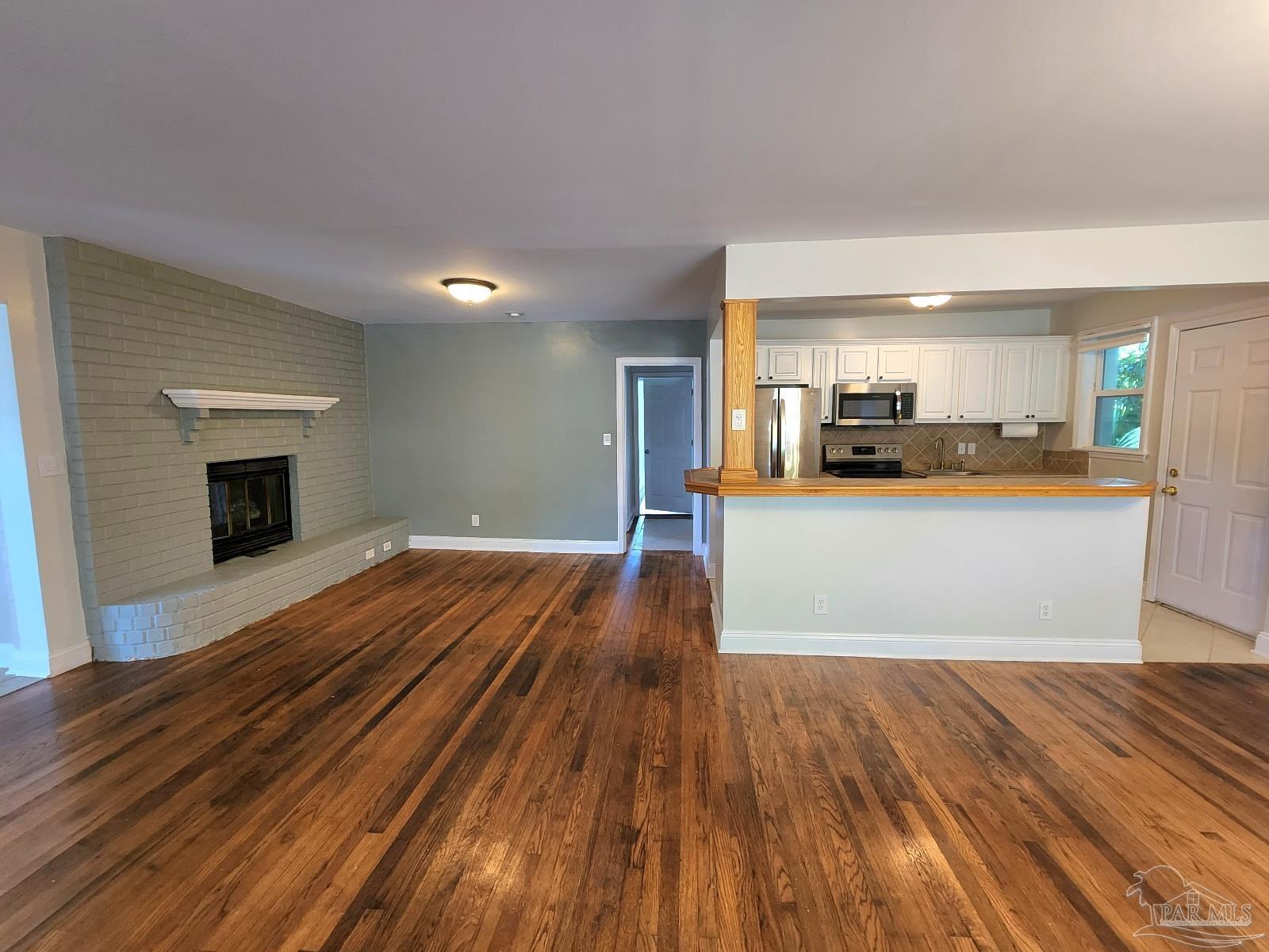 206 Berry Road Pensacola, FL 32507 - Photo 5 of 17 a view of a kitchen with furniture and wooden floor