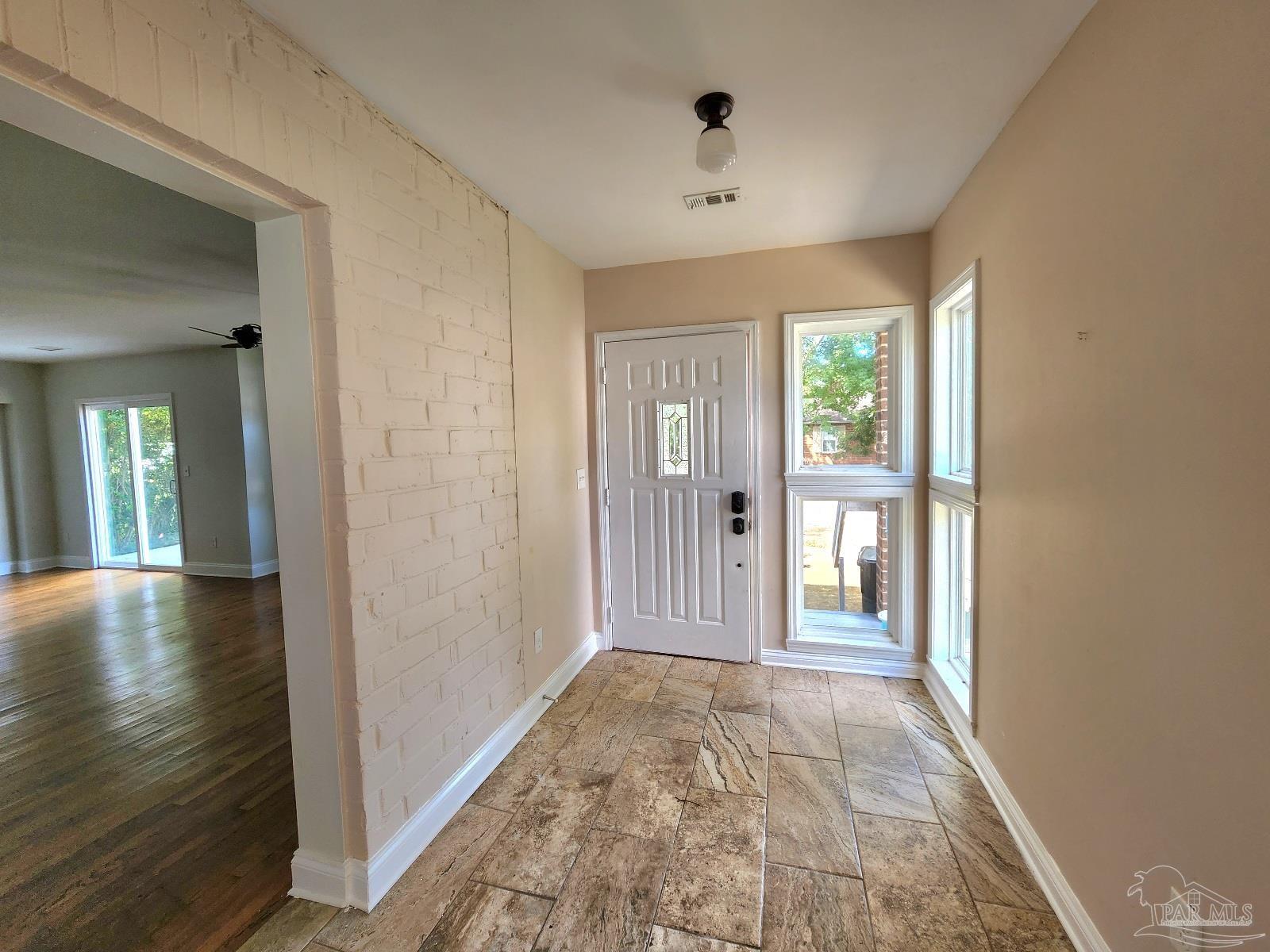 206 Berry Road Pensacola, FL 32507 - Photo 7 of 17 a view of hallway with livingroom and wooden floor