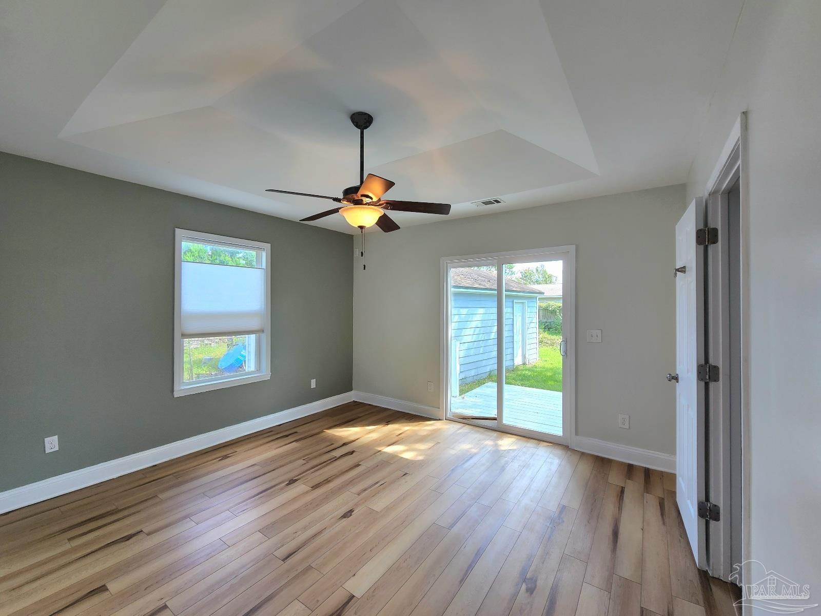 206 Berry Road Pensacola, FL 32507 - Photo 8 of 17 a view of an empty room with window and wooden floor