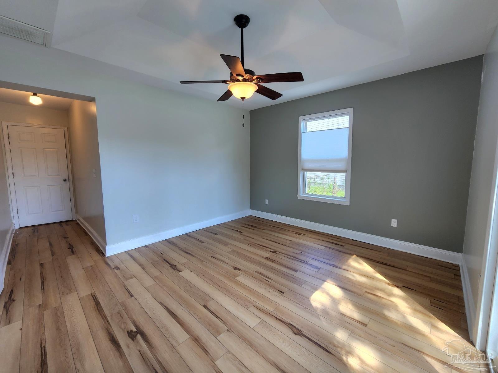 206 Berry Road Pensacola, FL 32507 - Photo 9 of 17 a view of empty room with wooden floor and fan