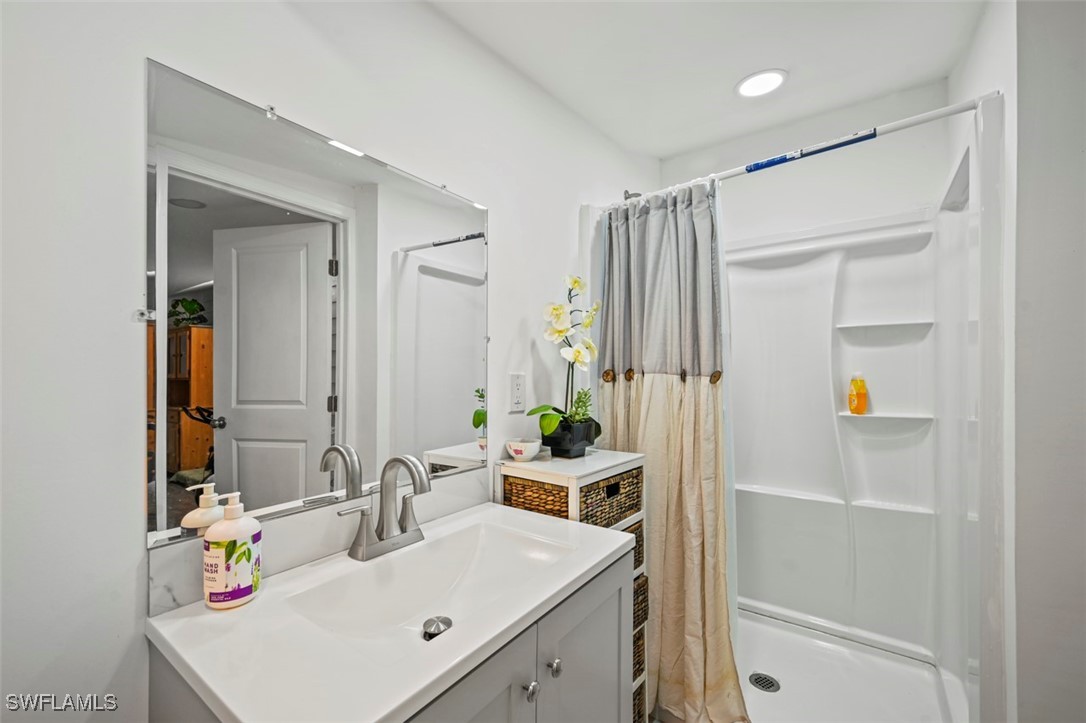 4832 Courtney Road St. James City, FL 33956 - Photo 22 of 35 a bathroom with a sink double vanity and a mirror