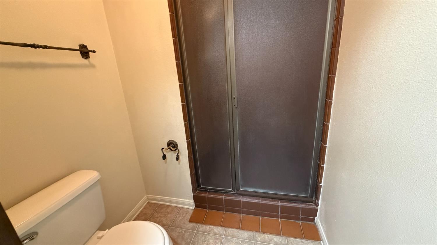 1555 West Boston Avenue, Unit 101 Fresno, CA 93711 - Photo 11 of 20 a bathroom with a granite countertop shower and a toilet