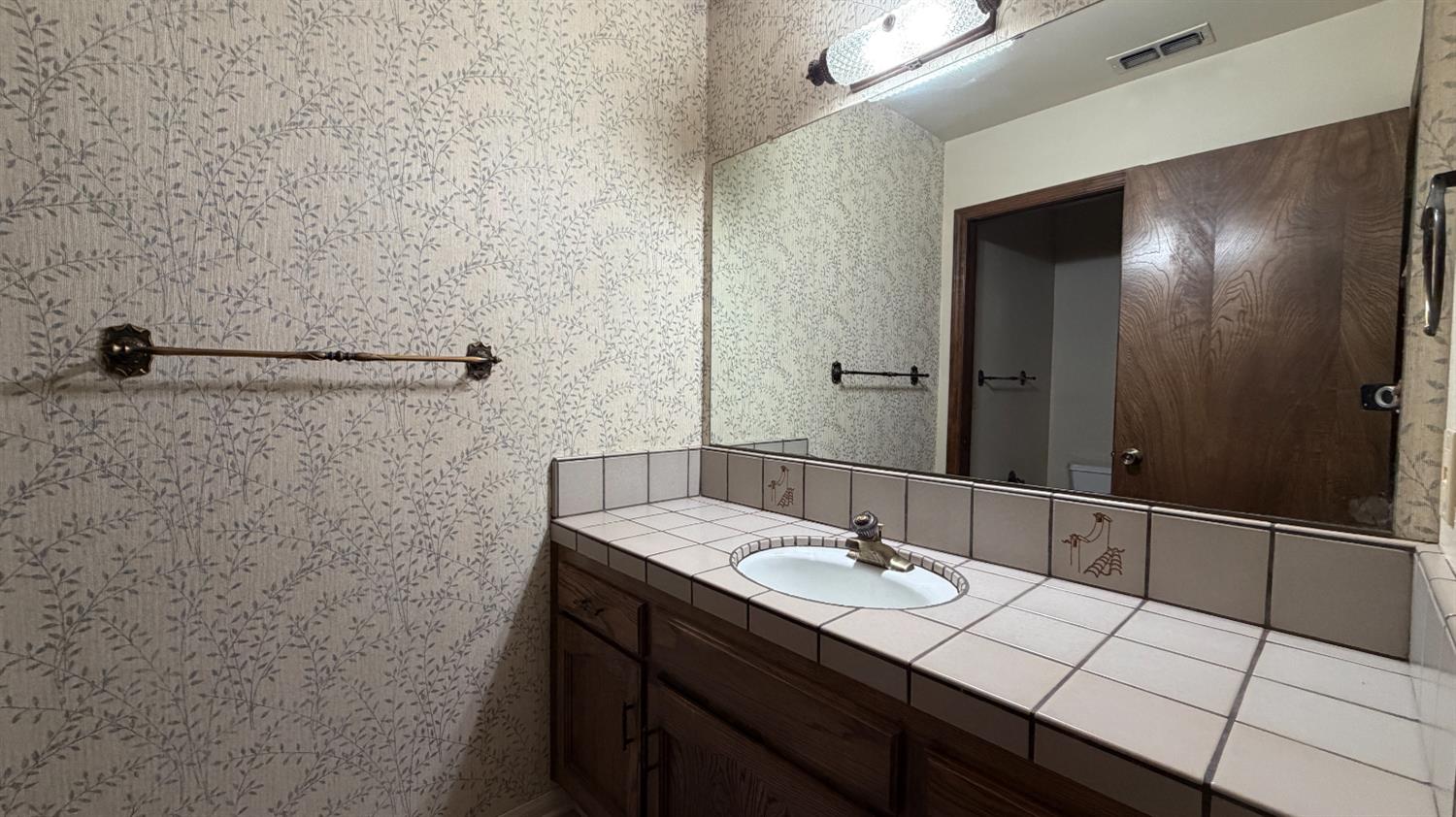 1555 West Boston Avenue, Unit 101 Fresno, CA 93711 - Photo 15 of 20 a bathroom with a sink and a mirror