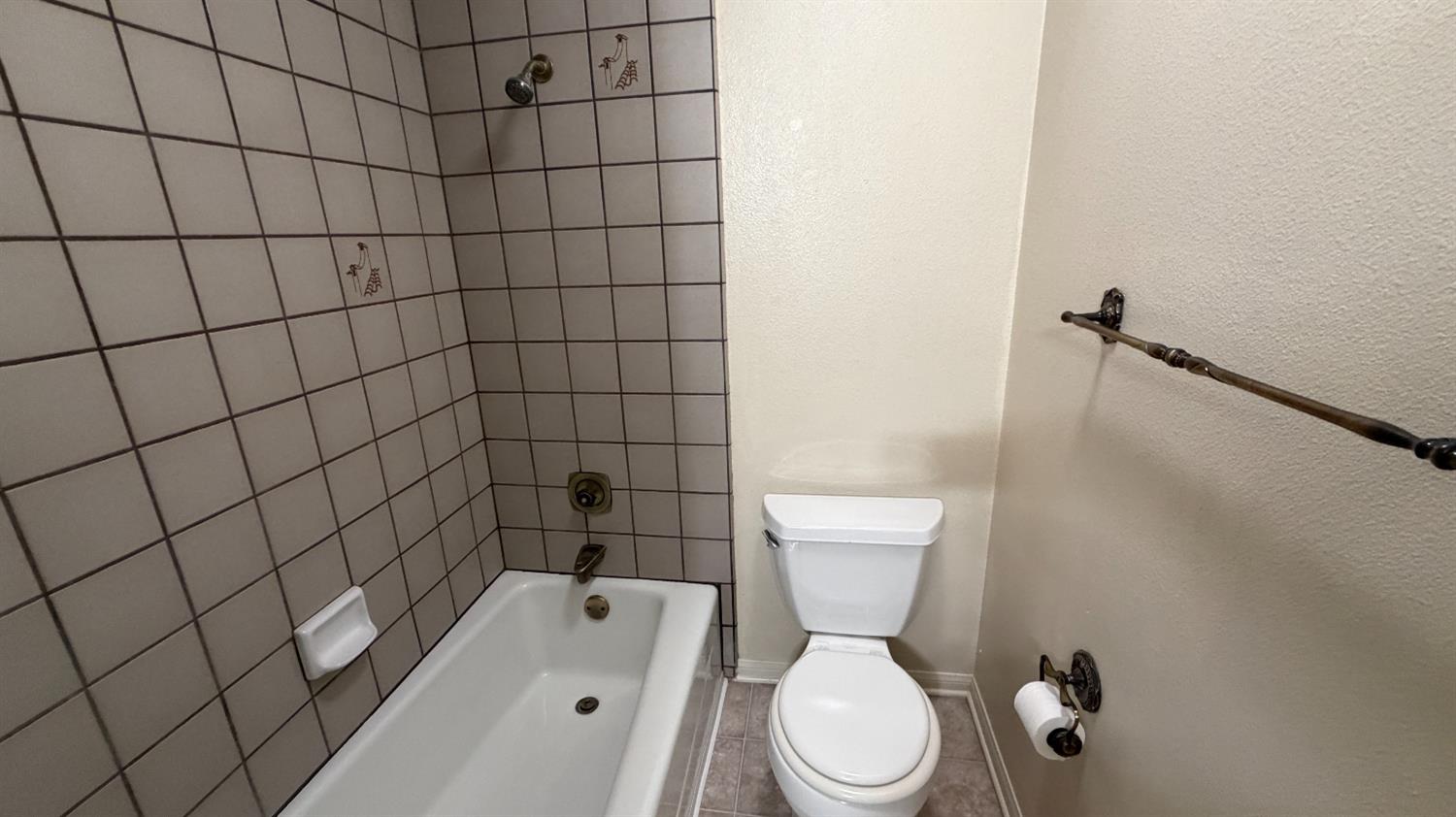 1555 West Boston Avenue, Unit 101 Fresno, CA 93711 - Photo 16 of 20 a white toilet sitting next to a bathroom sink