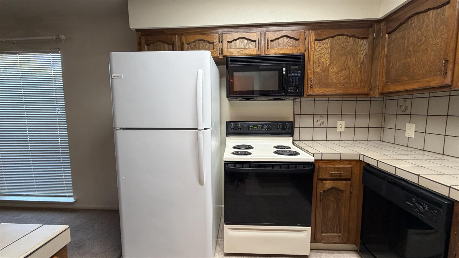 1555 West Boston Avenue, Unit 101 Fresno, CA 93711 - Photo 6 of 20 a view kitchen with a sink and a refrigerator