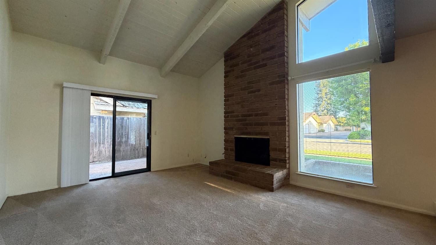 1555 West Boston Avenue, Unit 101 Fresno, CA 93711 - Photo 8 of 20 a view of an empty room with a fireplace and a window