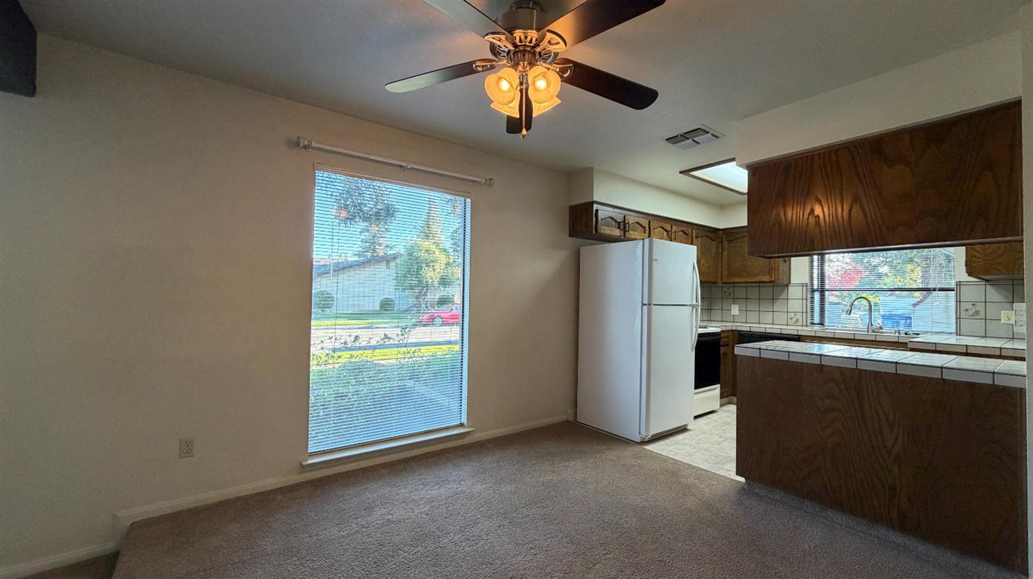 1555 West Boston Avenue, Unit 101 Fresno, CA 93711 - Photo 9 of 20 a kitchen with refrigerator and window
