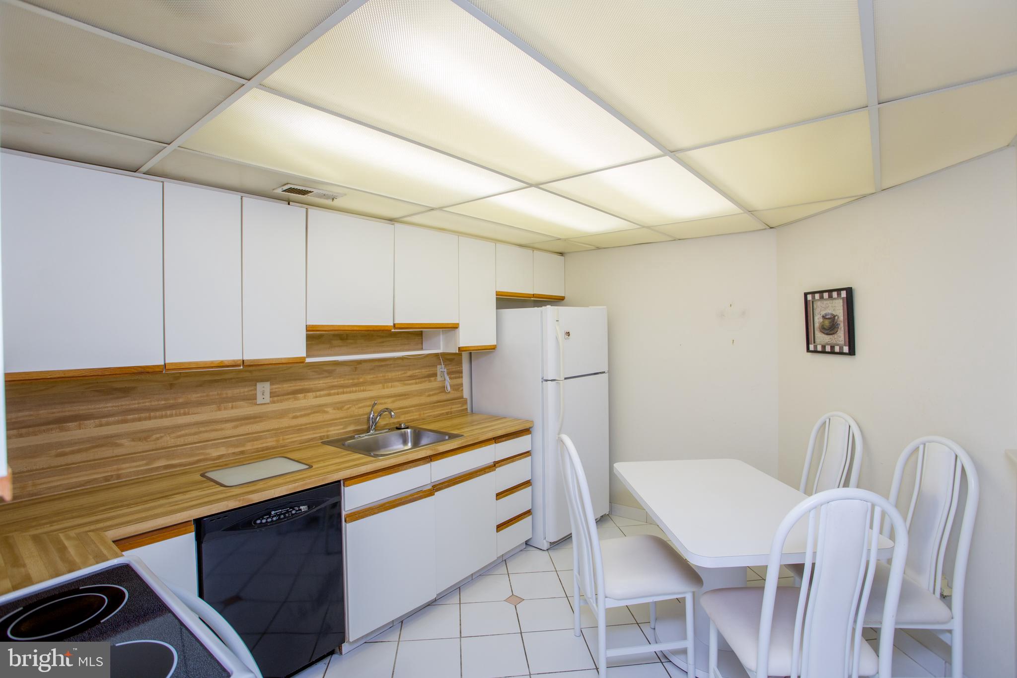 2131 Welsh Road, Unit 207 Philadelphia, PA 19115 - Photo 12 of 46 a kitchen with stainless steel appliances a stove a sink cabinets and a dining table