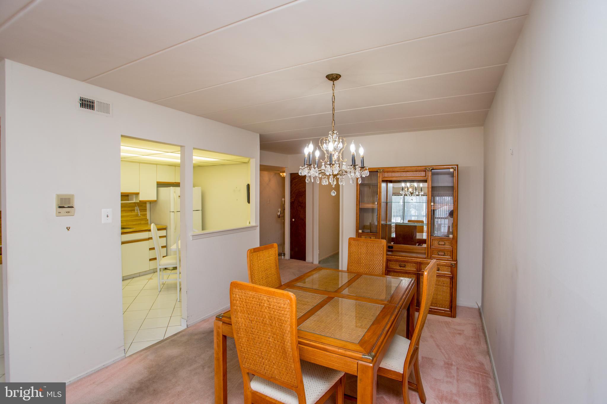 2131 Welsh Road, Unit 207 Philadelphia, PA 19115 - Photo 14 of 46 a view of a dining room with furniture and chandelier