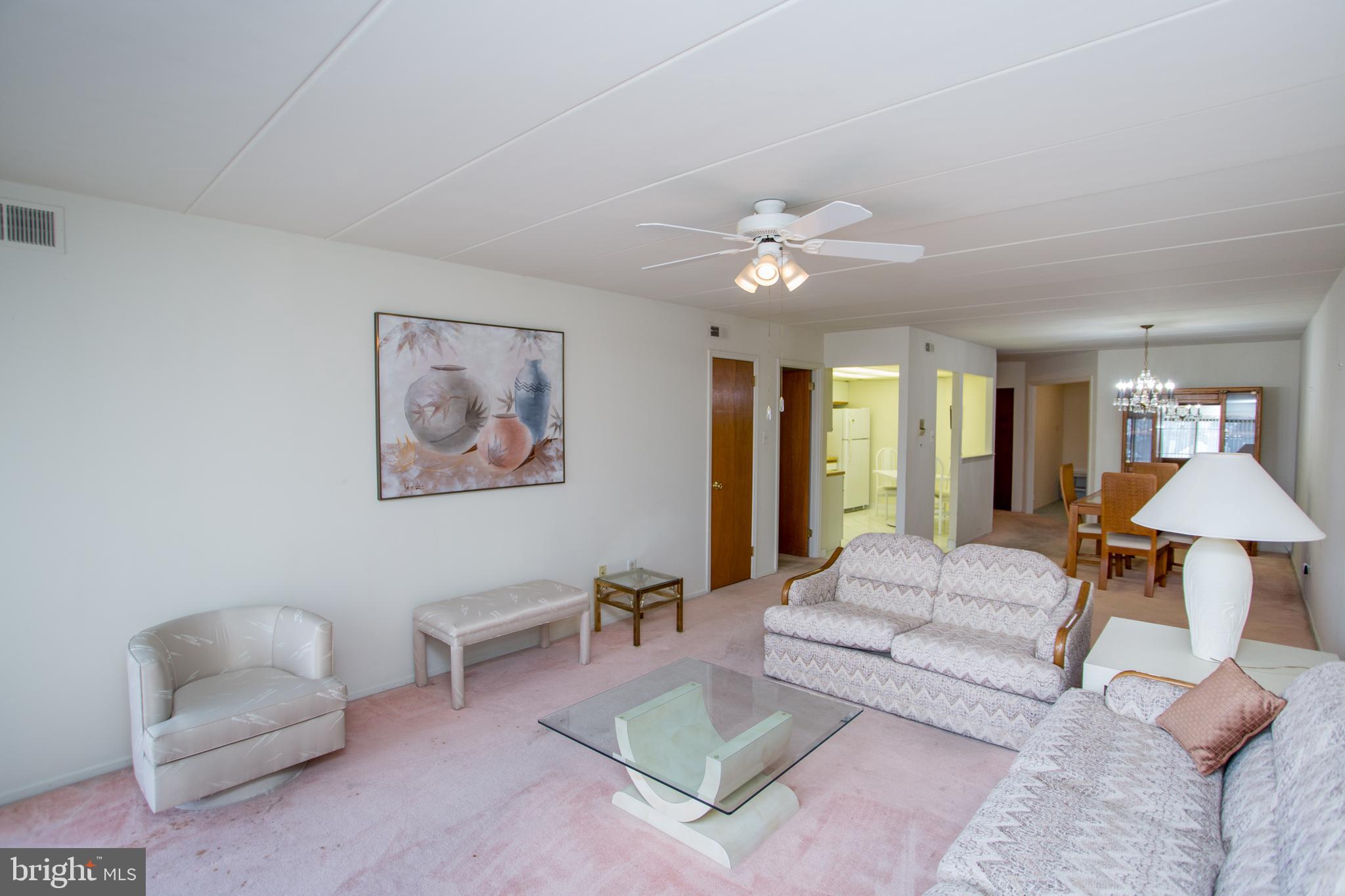 2131 Welsh Road, Unit 207 Philadelphia, PA 19115 - Photo 17 of 46 a living room with furniture and a chandelier