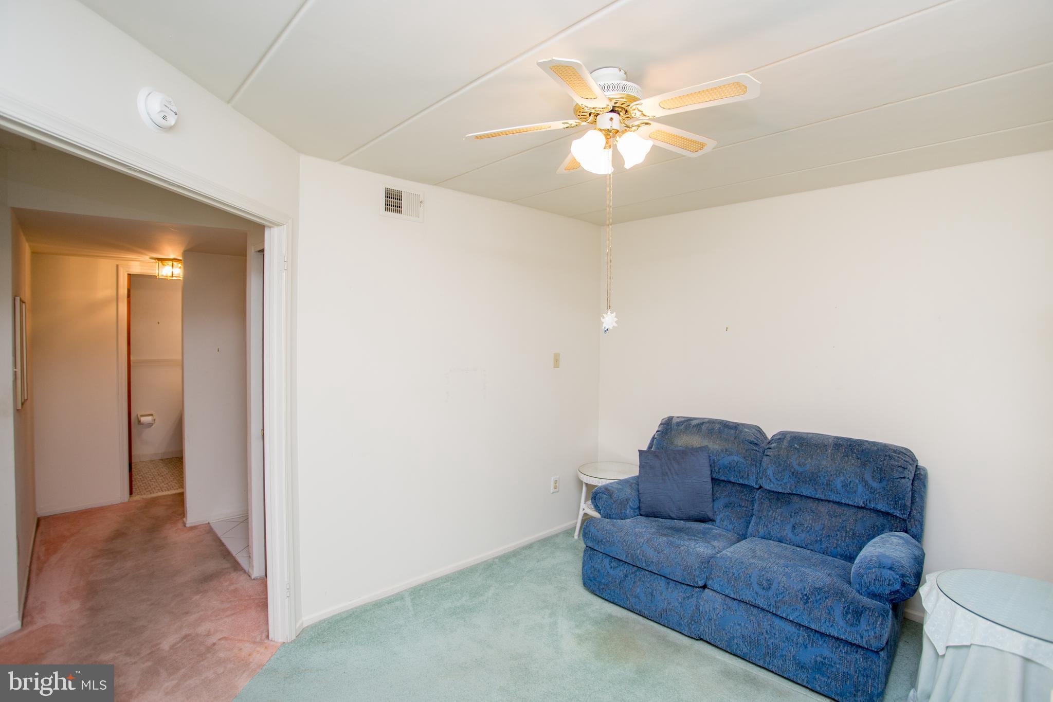 2131 Welsh Road, Unit 207 Philadelphia, PA 19115 - Photo 19 of 46 a living room with furniture and a chandelier