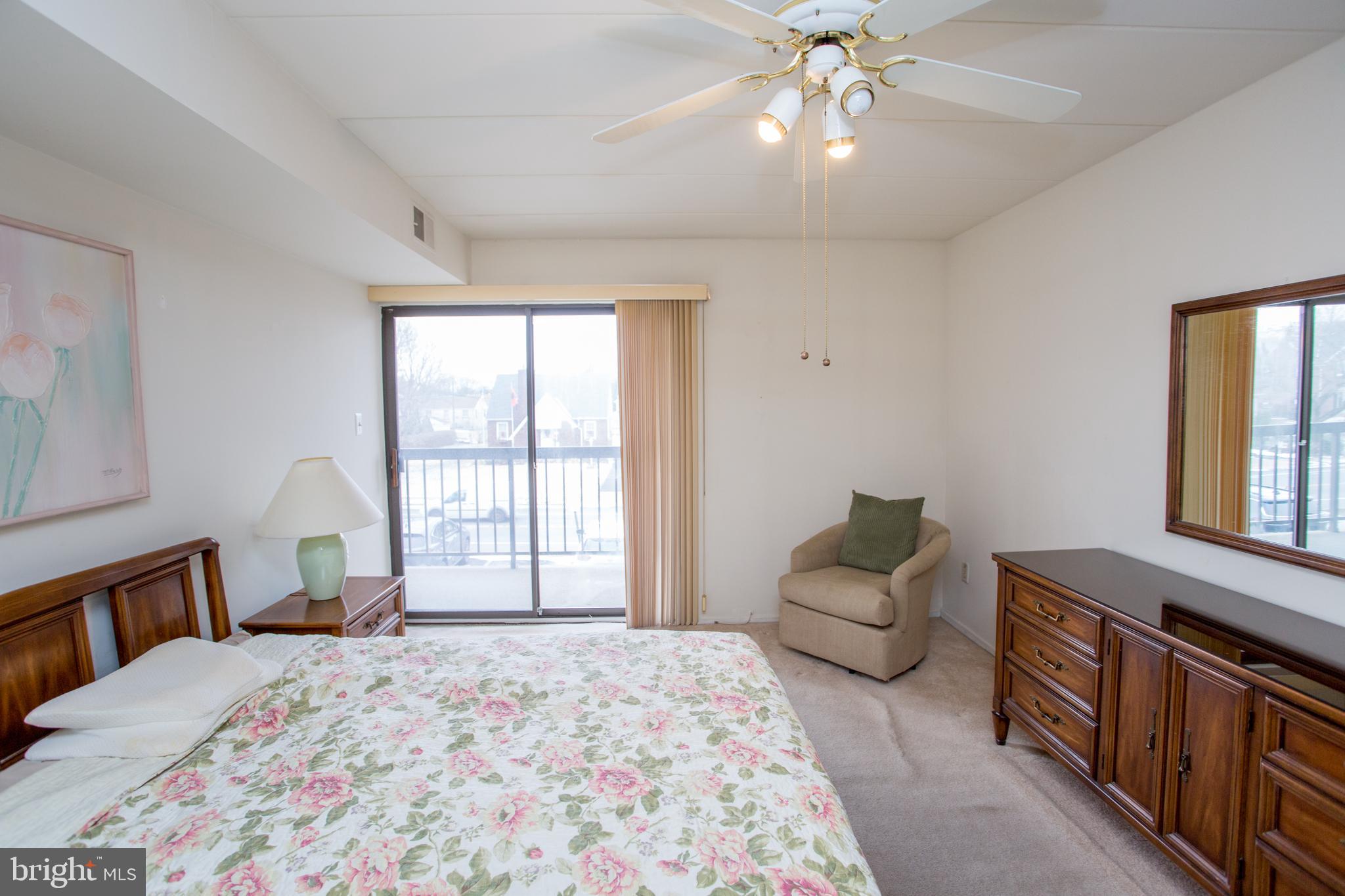 2131 Welsh Road, Unit 207 Philadelphia, PA 19115 - Photo 23 of 46 a bedroom with a bed couch and window