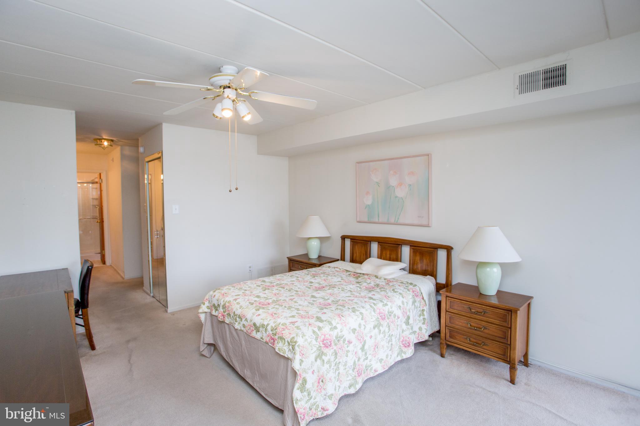 2131 Welsh Road, Unit 207 Philadelphia, PA 19115 - Photo 24 of 46 a bedroom with a bed and a chandelier