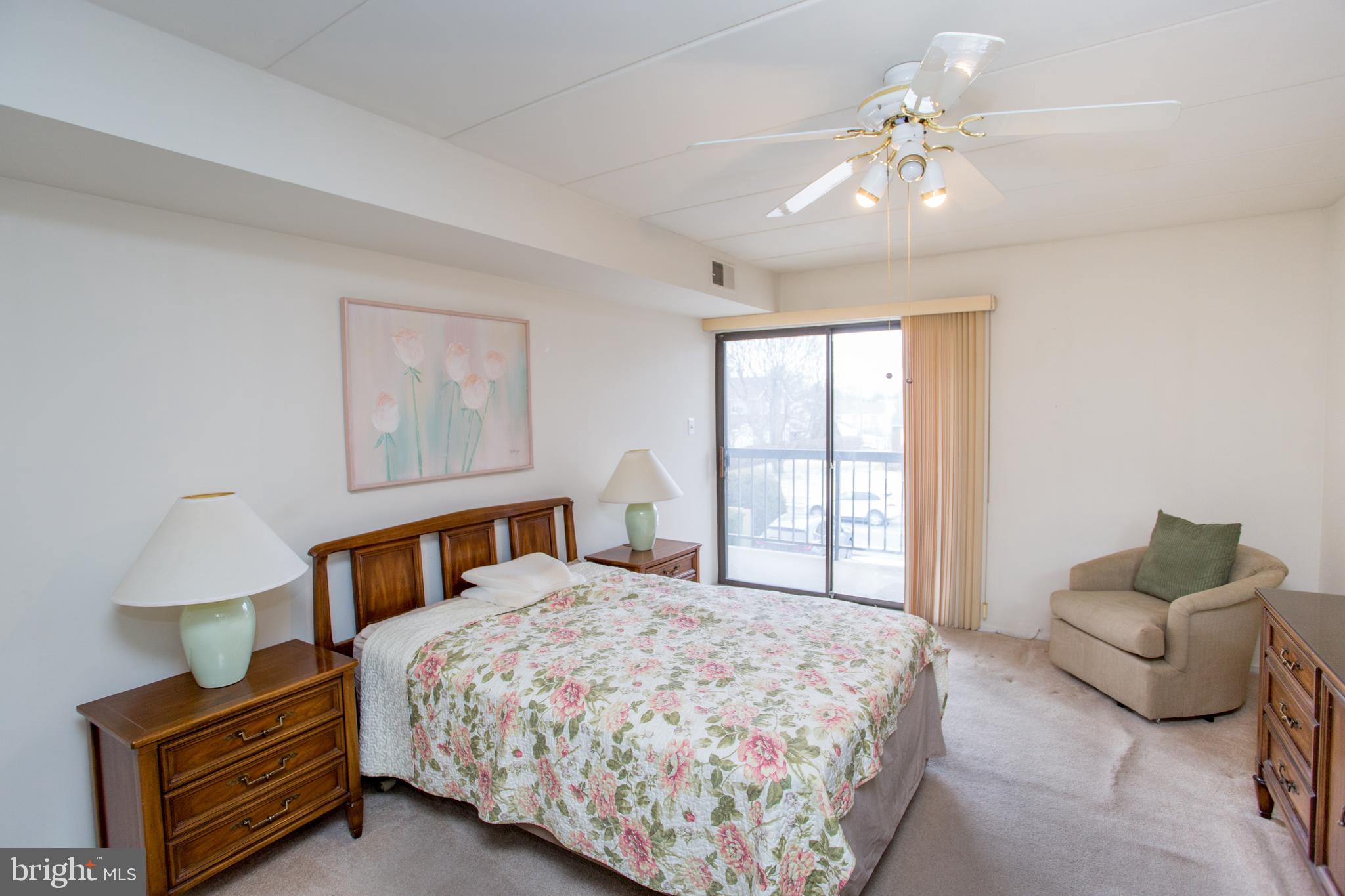 2131 Welsh Road, Unit 207 Philadelphia, PA 19115 - Photo 25 of 46 a bedroom with a bed and a chandelier