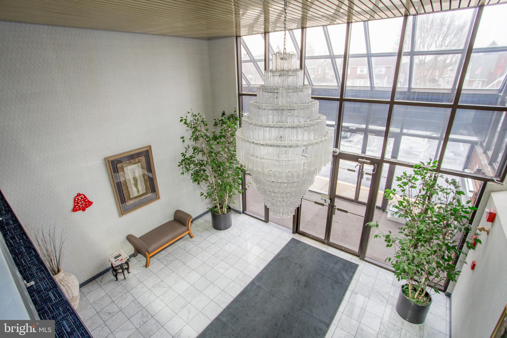 2131 Welsh Road, Unit 207 Philadelphia, PA 19115 - Photo 5 of 46 a living room with furniture and a potted plant