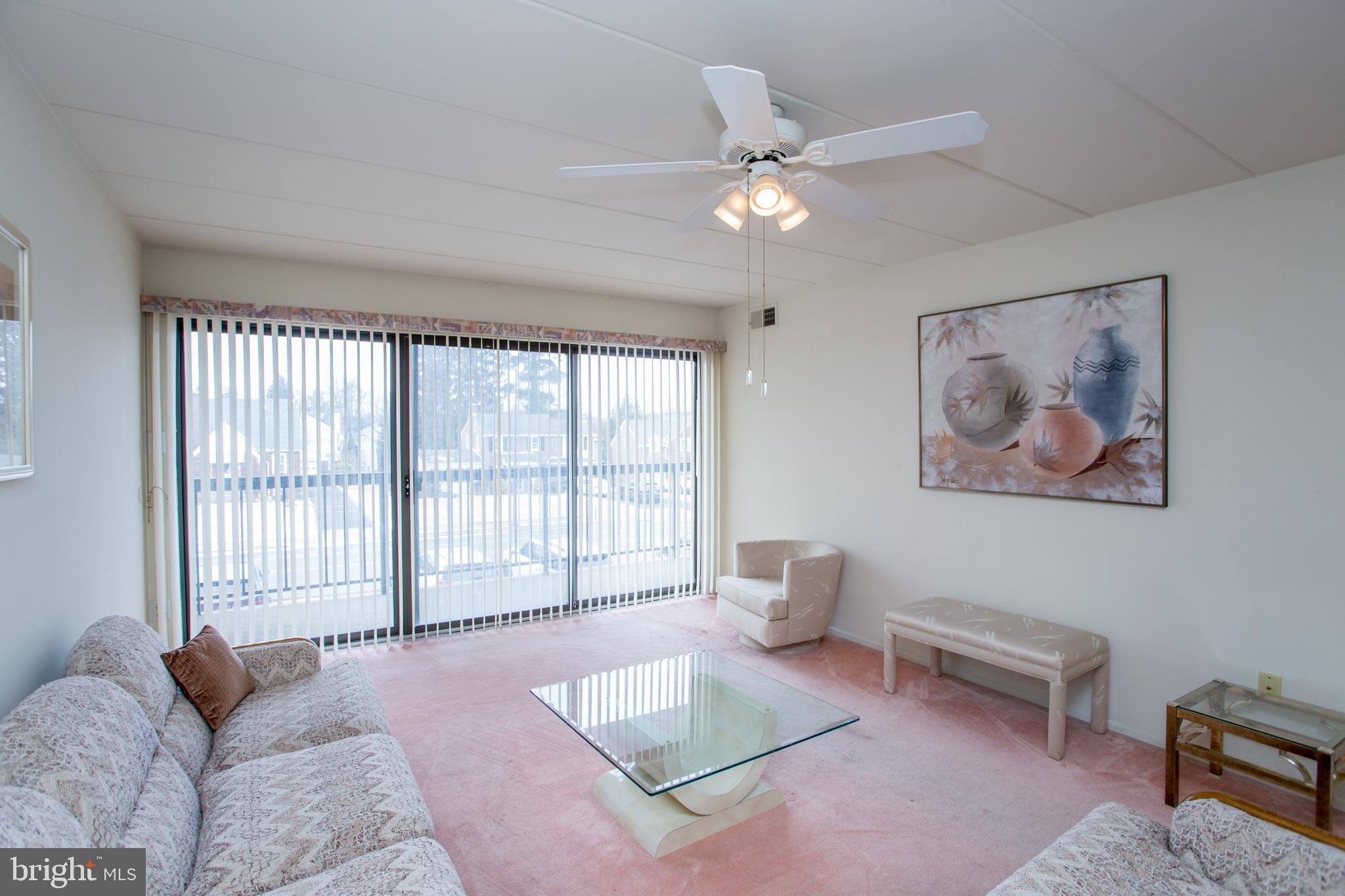 2131 Welsh Road, Unit 207 Philadelphia, PA 19115 - Photo 9 of 46 a living room with furniture and a large window