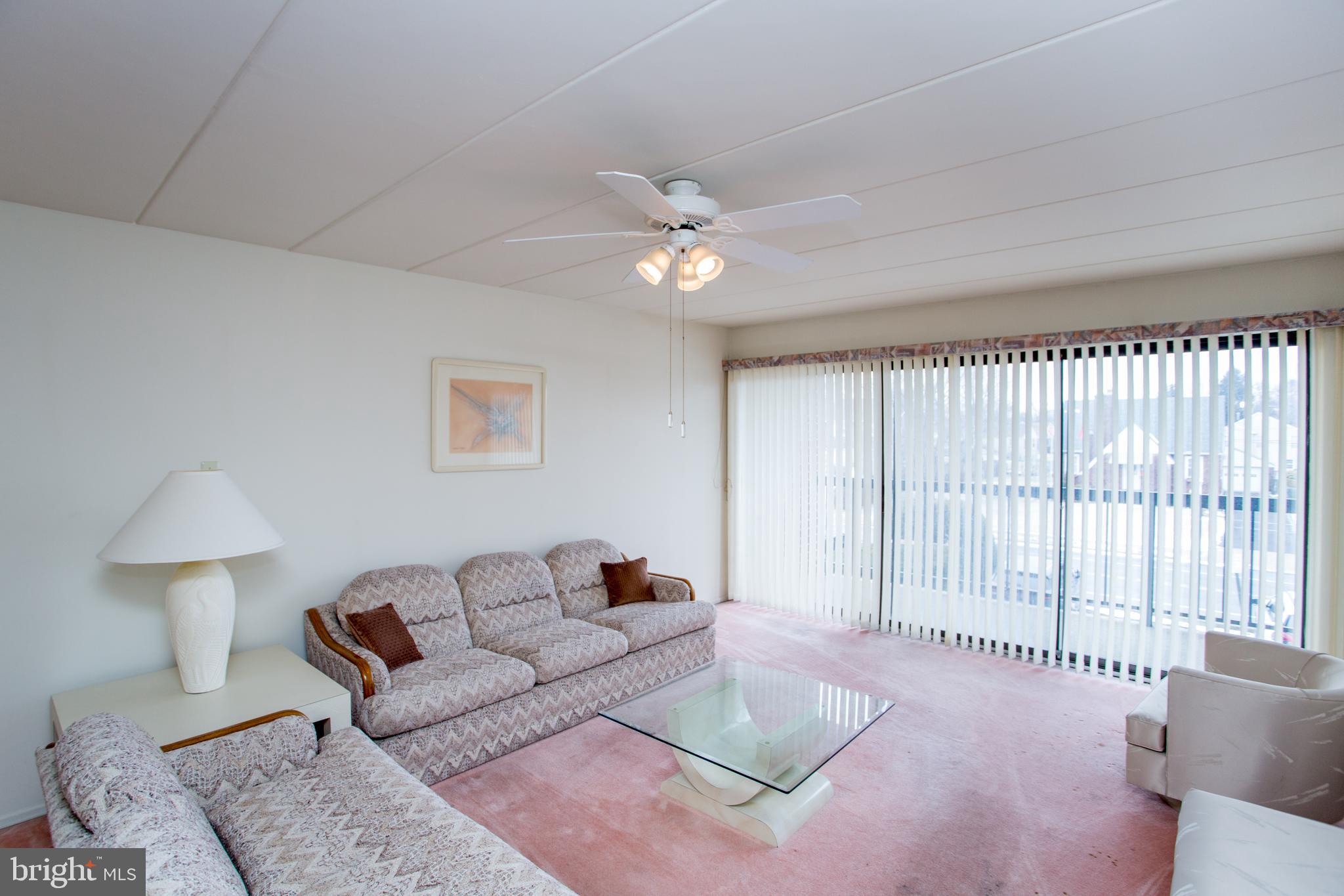 2131 Welsh Road, Unit 207 Philadelphia, PA 19115 - Photo 10 of 46 a living room with furniture and a large window