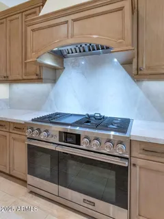 a stove top oven sitting inside of a kitchen