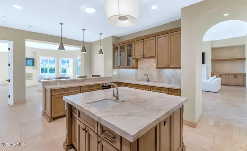 a kitchen with center island table and chairs