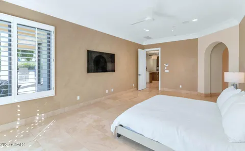 a bedroom with a large bed and a flat screen tv