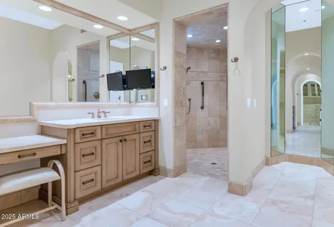 a spacious bathroom with a granite countertop sink mirror and shower