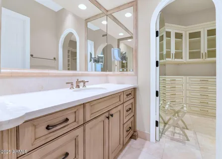 a spacious bathroom with a sink and a mirror