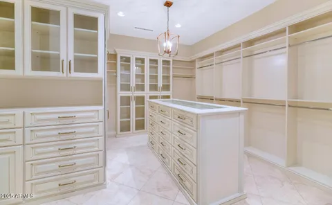 a view of walk in closet and window