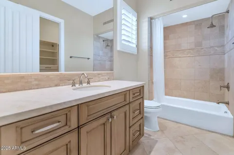 a utility room with cabinets washer and dryer