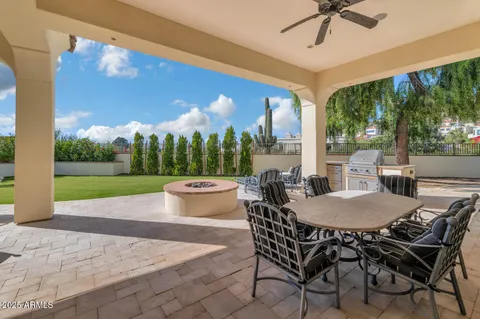 a view of a patio with couches table and chairs and potted plants