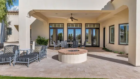 a dining room with furniture and a floor to ceiling window