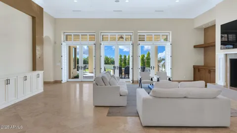 a living room with furniture and large windows