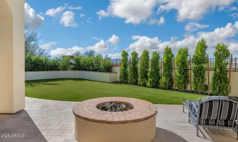 an aerial view of residential houses with outdoor space and trees all around