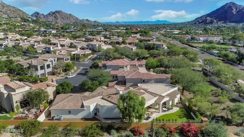 an aerial view of residential houses with outdoor space and trees