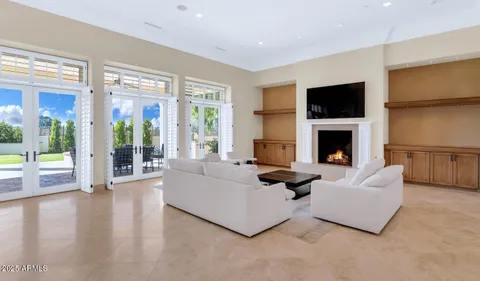a living room with furniture flat screen tv and a fireplace