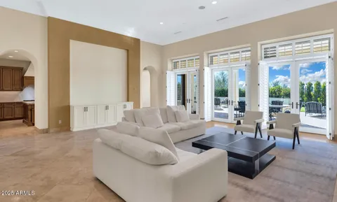 a living room with furniture and large windows