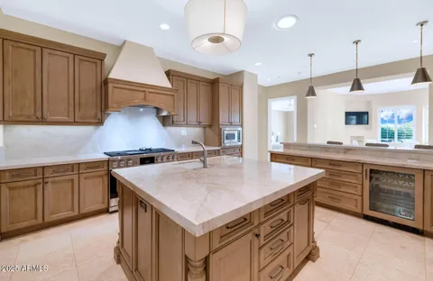 a kitchen with a stove a sink and a refrigerator