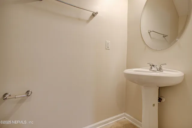 a bathroom with a sink and mirror