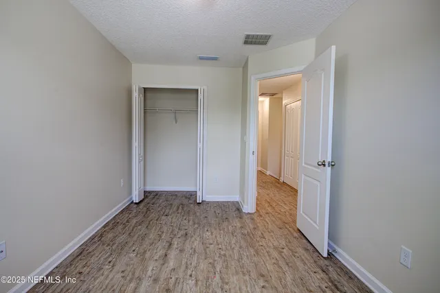 a view of hallway with wooden floor