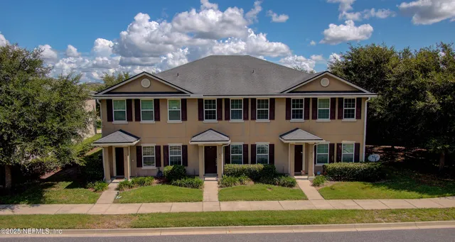 an aerial view of a house with a garden and swimming pool