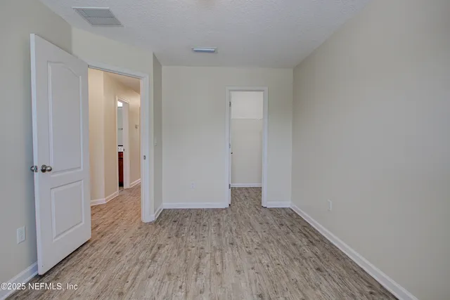 a view of hallway with wooden floor