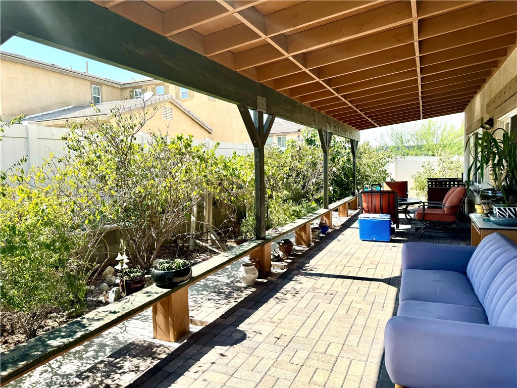 37041 Populus Avenue Palmdale, CA 93552 - Photo 14 of 30 a view of a balcony with chairs and wooden floor