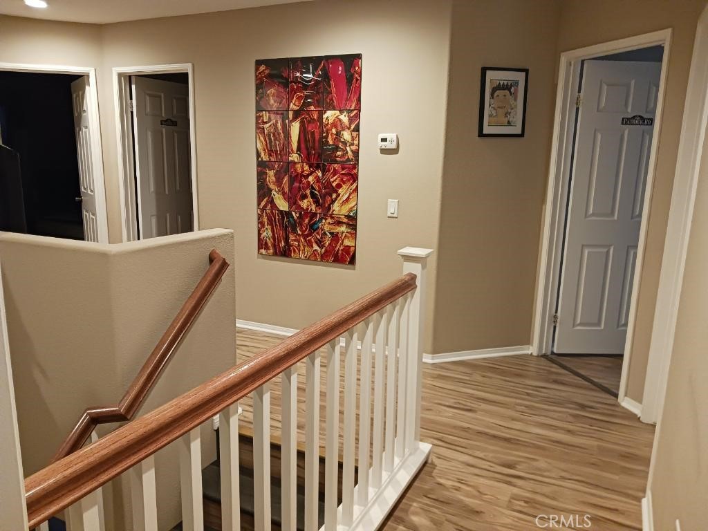 37041 Populus Avenue Palmdale, CA 93552 - Photo 17 of 30 a view of a hallway with wooden floor and stairs