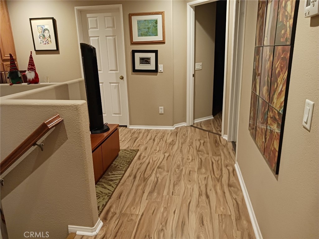 37041 Populus Avenue Palmdale, CA 93552 - Photo 18 of 30 a view of a room with wooden floor and a bathroom