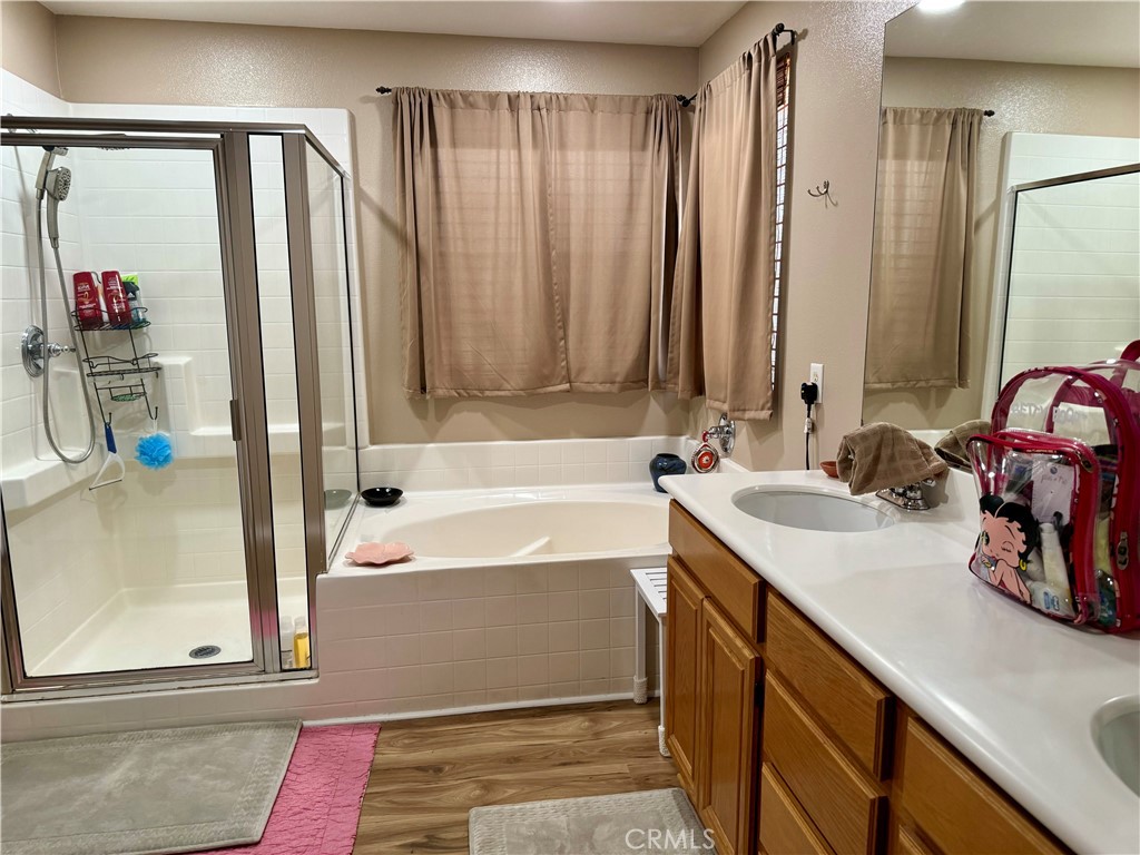 37041 Populus Avenue Palmdale, CA 93552 - Photo 23 of 30 a bathroom with a tub sink and a mirror