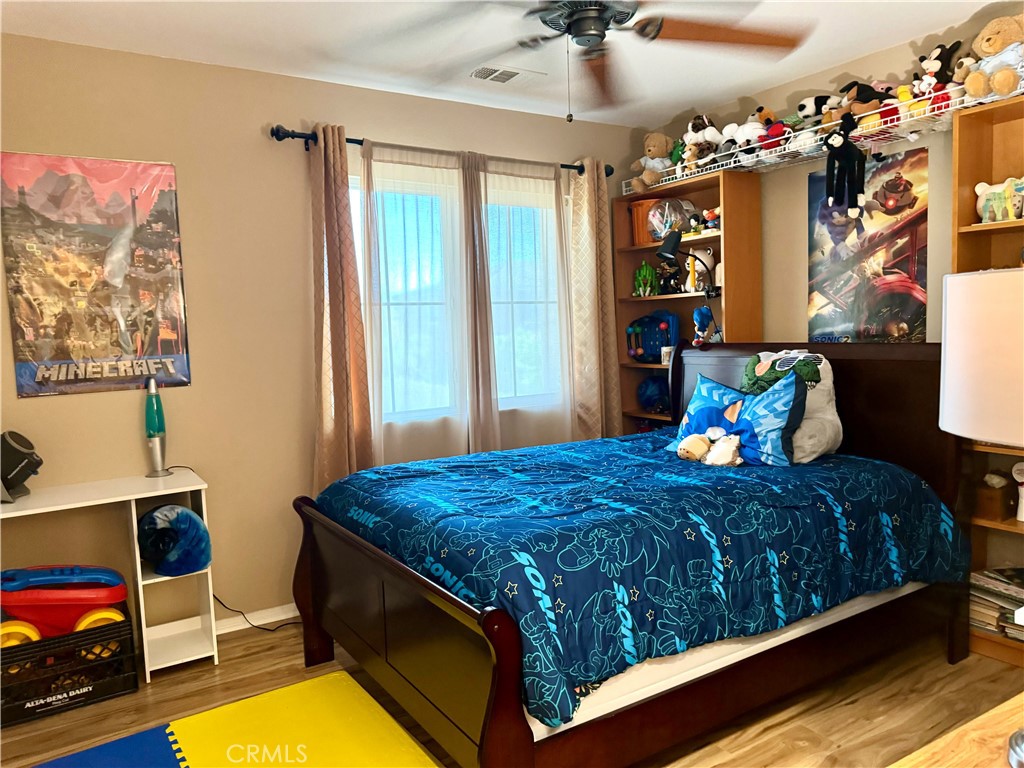 37041 Populus Avenue Palmdale, CA 93552 - Photo 25 of 30 a bedroom with bed and window