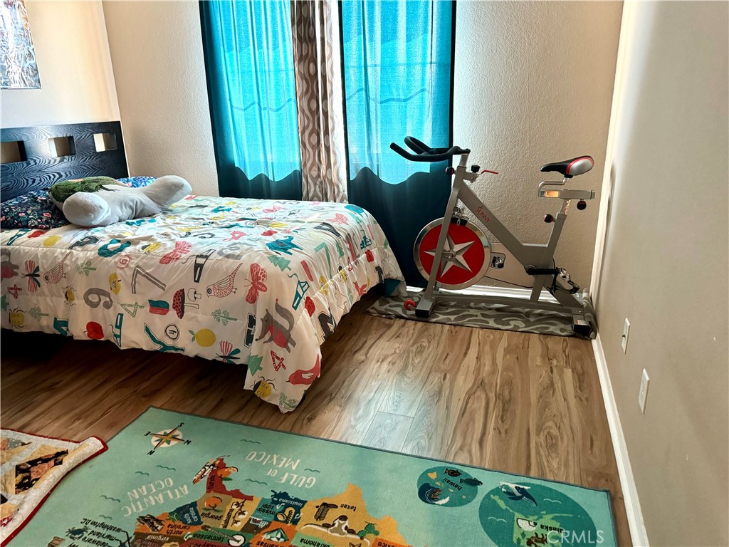 37041 Populus Avenue Palmdale, CA 93552 - Photo 26 of 30 a bedroom with a bed and a dresser