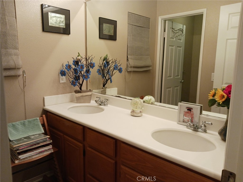 37041 Populus Avenue Palmdale, CA 93552 - Photo 27 of 30 a bathroom with a sink and a mirror