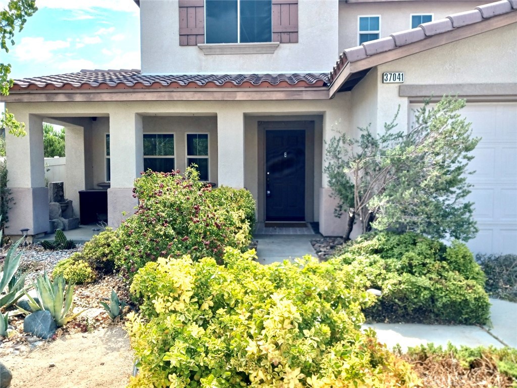 37041 Populus Avenue Palmdale, CA 93552 - Photo 3 of 30 front view of a house with a yard