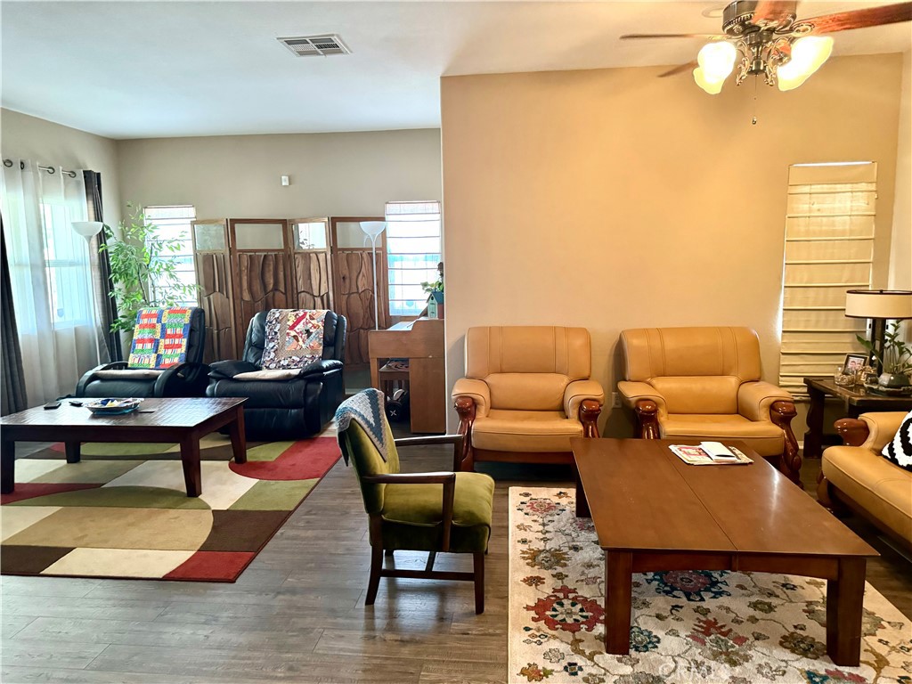37041 Populus Avenue Palmdale, CA 93552 - Photo 5 of 30 a living room with furniture a rug and a lamp