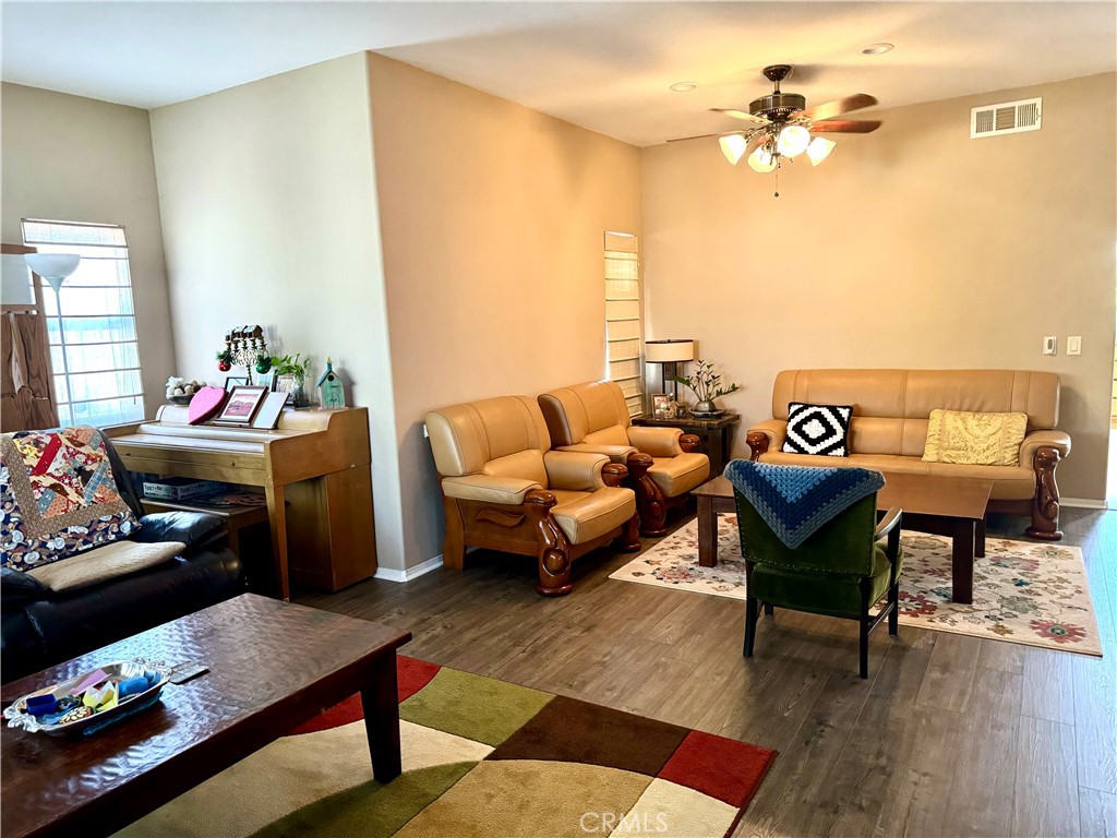 37041 Populus Avenue Palmdale, CA 93552 - Photo 6 of 30 a bedroom with furniture and a wooden floor